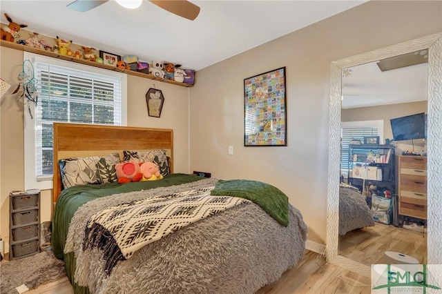 bedroom with ceiling fan and light hardwood / wood-style floors