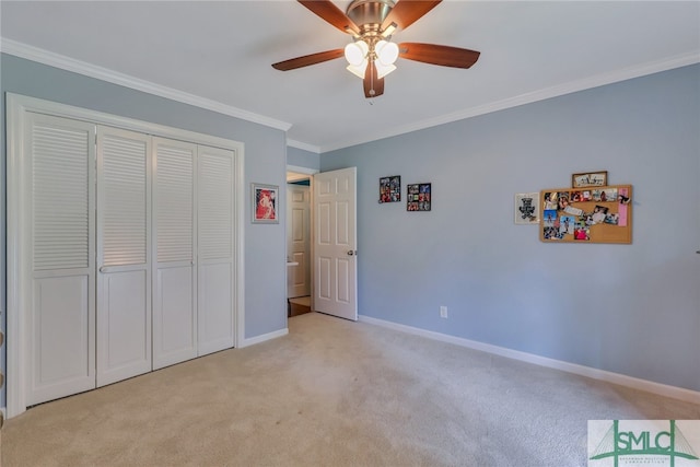 unfurnished bedroom featuring light carpet, a closet, ceiling fan, and ornamental molding