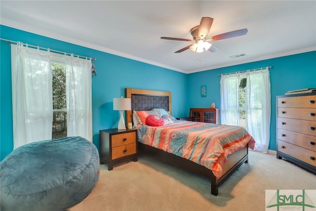 bedroom with ceiling fan, crown molding, and light colored carpet