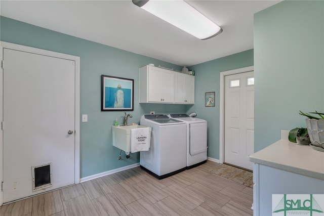 laundry room featuring sink, cabinets, and independent washer and dryer