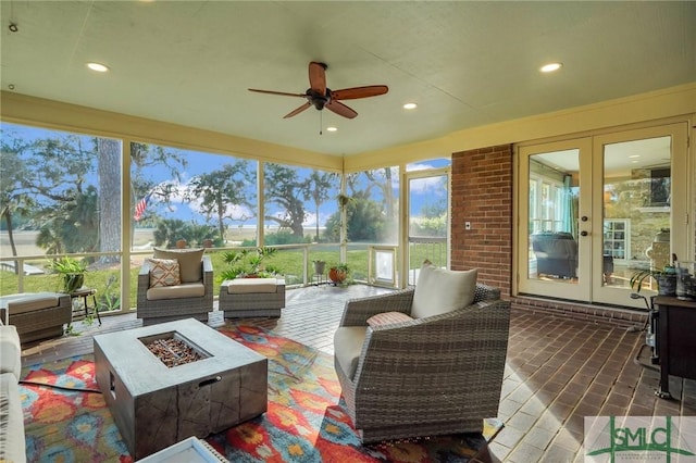 sunroom featuring french doors and ceiling fan