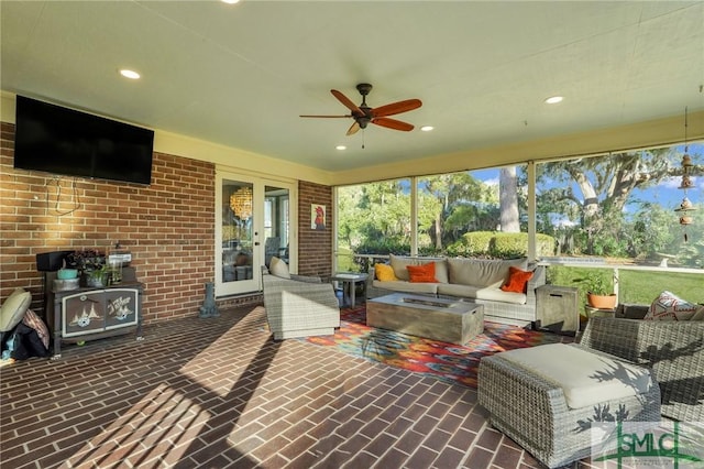 sunroom featuring ceiling fan