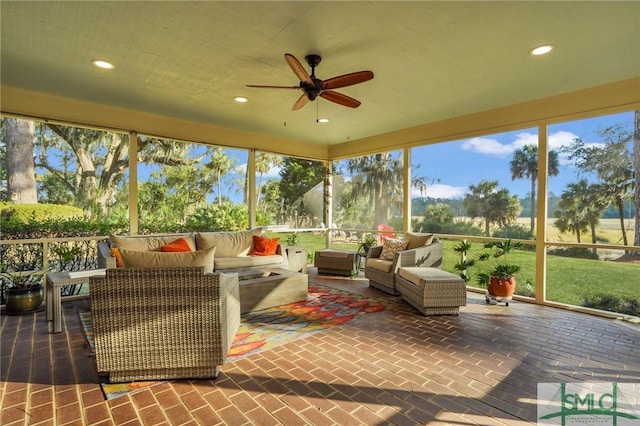 sunroom / solarium featuring ceiling fan and a healthy amount of sunlight