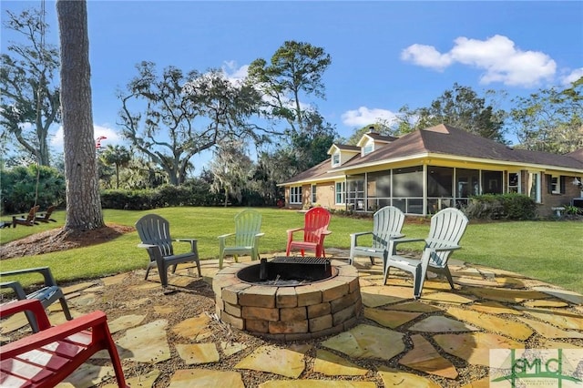 view of patio featuring a fire pit and a sunroom