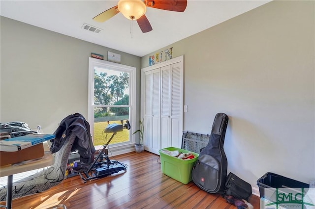 recreation room with ceiling fan and wood-type flooring