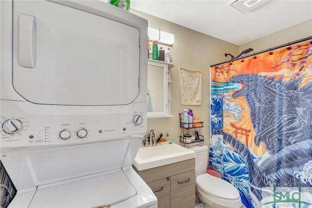 interior space with stacked washer and dryer and sink