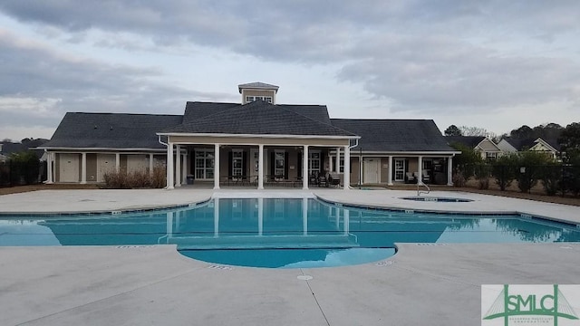 view of pool featuring an in ground hot tub and a patio