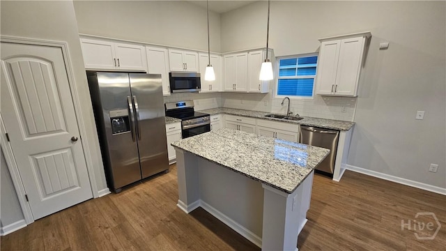 83 Marsh Salt Ln, Port Wentworth, GA 31407 - kitchen with appliances with stainless steel finishes, dark wood-style flooring, decorative backsplash, a center island, and white cabinetry