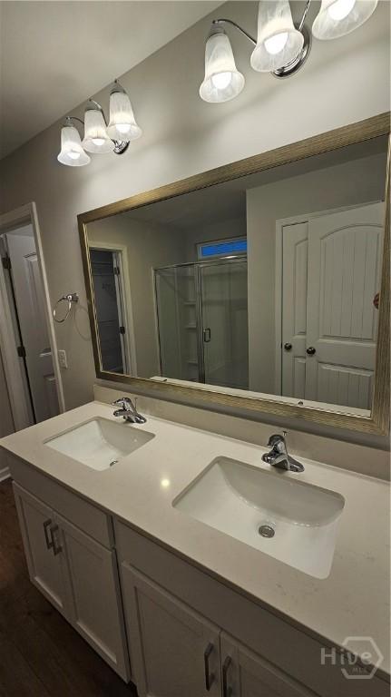 83 Marsh Salt Ln, Port Wentworth, GA 31407 - bathroom featuring double vanity, wood finished floors, and a shower with shower door