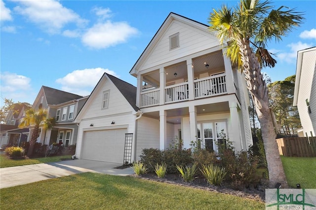 view of front of home with a garage, a balcony, and a front yard