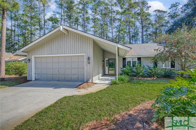 ranch-style house featuring a garage and a front lawn