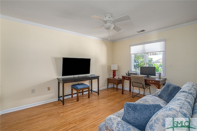 living room with ceiling fan, crown molding, a textured ceiling, and light wood-type flooring