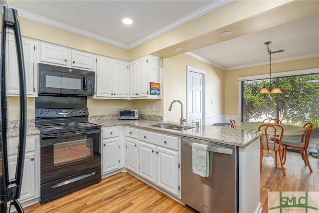 kitchen featuring kitchen peninsula, sink, white cabinets, and black appliances