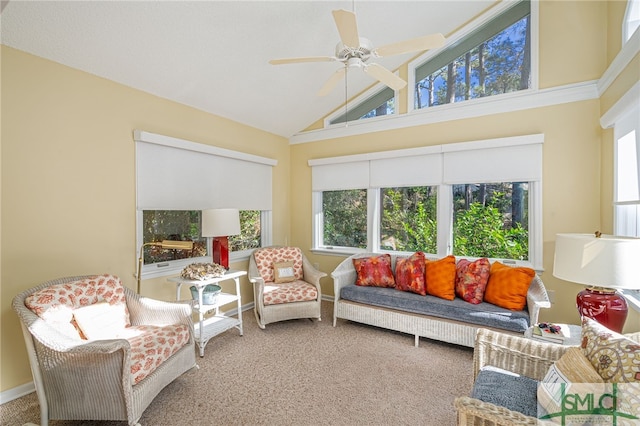 sunroom featuring ceiling fan, a healthy amount of sunlight, and vaulted ceiling