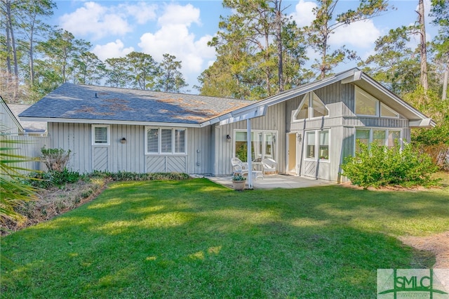 rear view of house featuring a patio area and a yard