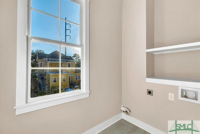 laundry room featuring tile patterned flooring, washer hookup, built in features, and hookup for an electric dryer