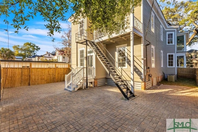 back of house with a patio and central AC