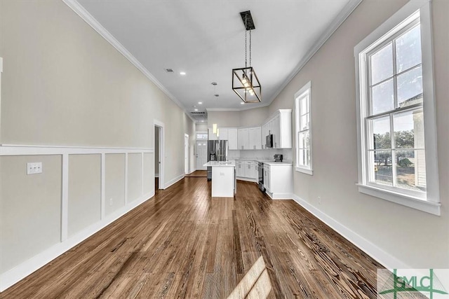 unfurnished living room with crown molding and dark hardwood / wood-style floors