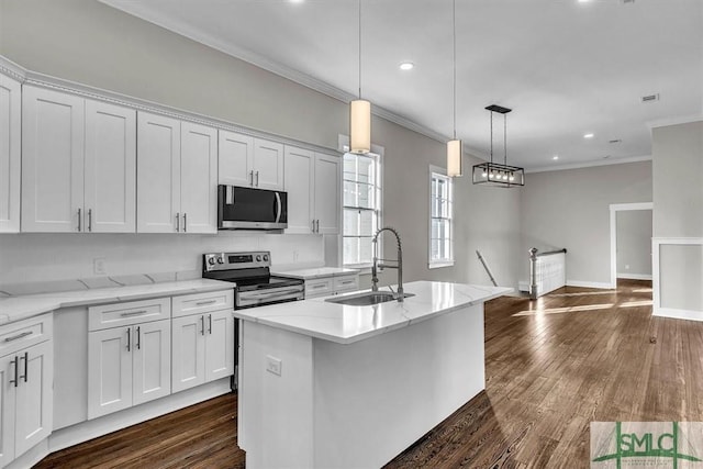 kitchen featuring white cabinetry, a center island with sink, stainless steel appliances, and sink