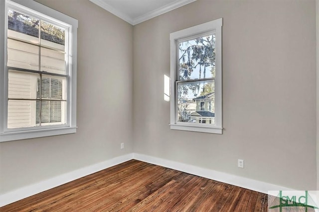 empty room featuring hardwood / wood-style flooring and ornamental molding