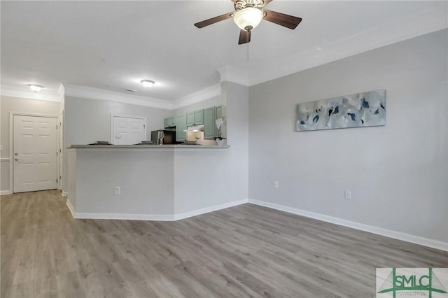 interior space featuring kitchen peninsula, light hardwood / wood-style flooring, fridge, and ceiling fan