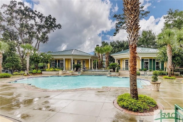 view of pool with an in ground hot tub