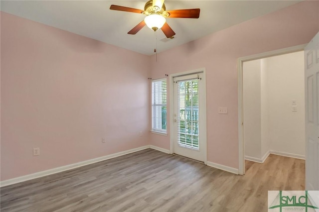 empty room with light hardwood / wood-style flooring and ceiling fan