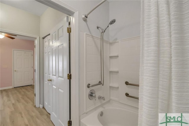 bathroom featuring ceiling fan, shower / bath combo, and hardwood / wood-style flooring