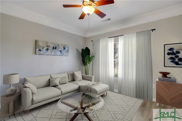 living room featuring light wood-type flooring, ceiling fan, and crown molding