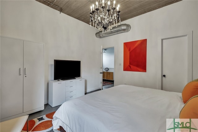 bedroom featuring a notable chandelier and wooden ceiling