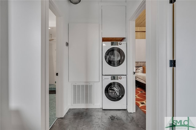 laundry room with stacked washer / drying machine