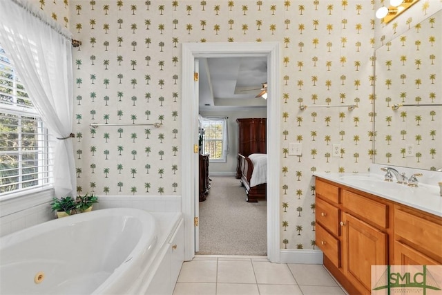 bathroom featuring tile patterned floors, ceiling fan, vanity, and a bathing tub