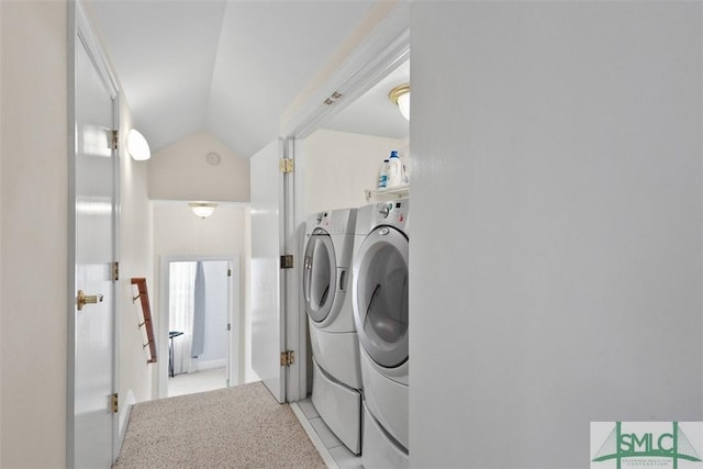 laundry room featuring washing machine and dryer and light tile patterned flooring