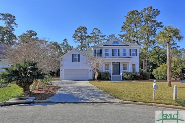 view of front of home with covered porch, a front lawn, and a garage