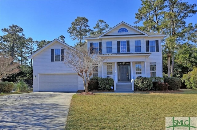 view of front of house with a front yard and a garage