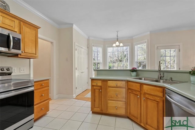 kitchen featuring hanging light fixtures, stainless steel appliances, sink, light tile patterned floors, and crown molding