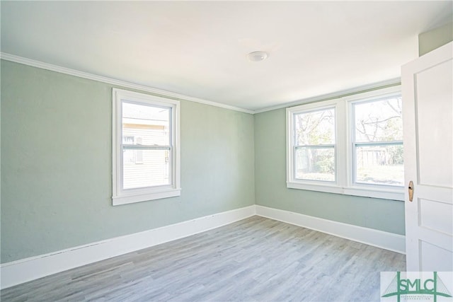 empty room featuring light hardwood / wood-style floors and ornamental molding