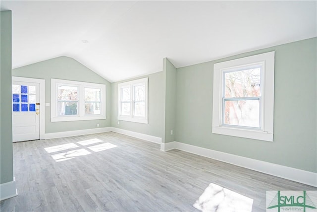 unfurnished living room with light hardwood / wood-style floors and lofted ceiling