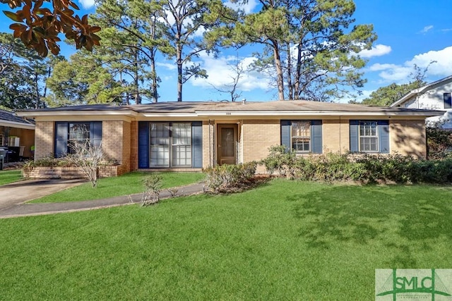 ranch-style home with brick siding and a front yard