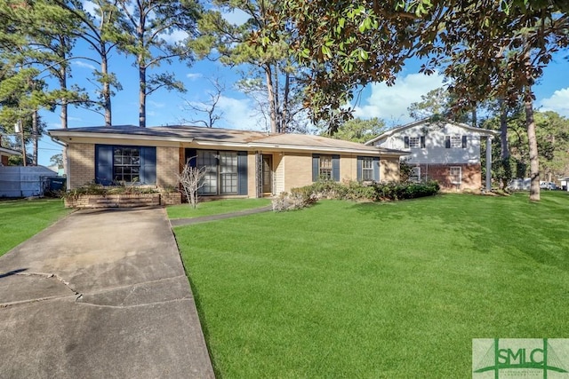 split level home with brick siding and a front lawn