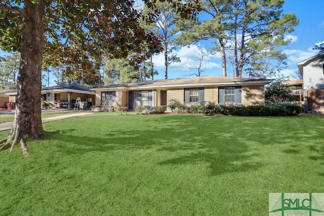 ranch-style home with a carport, a front yard, and brick siding