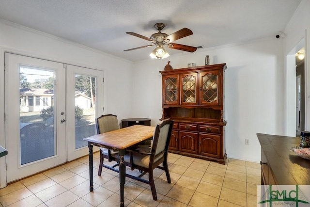 dining room with ceiling fan, light tile patterned floors, ornamental molding, and french doors