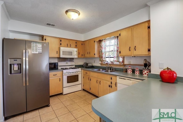 kitchen with white appliances, visible vents, dark countertops, a sink, and light tile patterned flooring