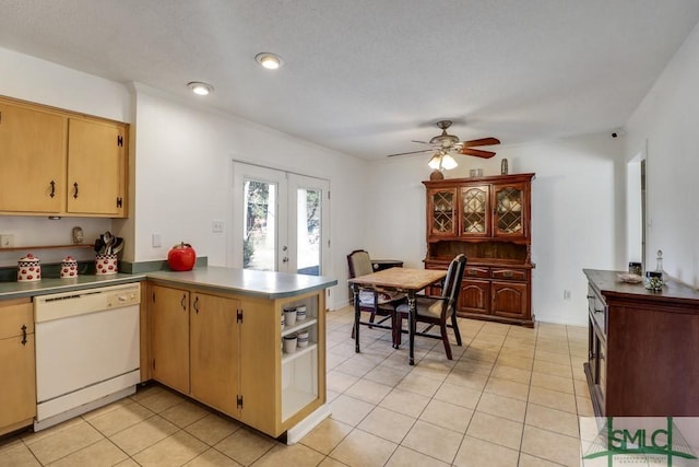 kitchen with light tile patterned floors, open shelves, a ceiling fan, white dishwasher, and a peninsula