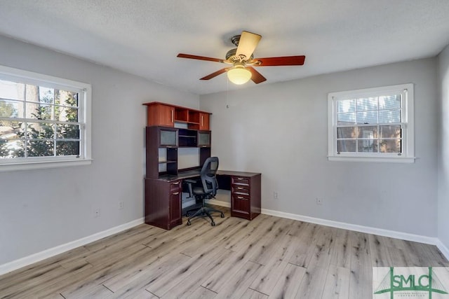 office space with ceiling fan and light wood-type flooring