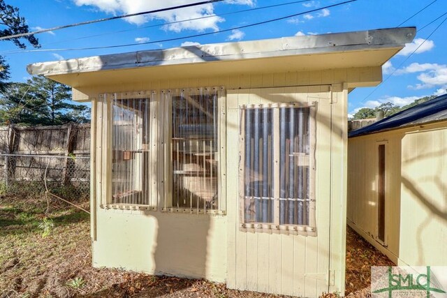 view of outdoor structure with an outbuilding and fence