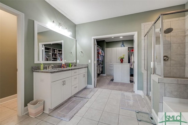 bathroom with tile patterned floors, vanity, and a shower with shower door