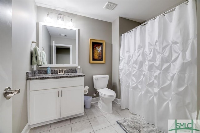 bathroom featuring tile patterned floors, vanity, and toilet