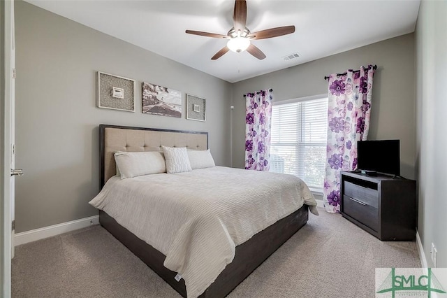 bedroom featuring light colored carpet and ceiling fan