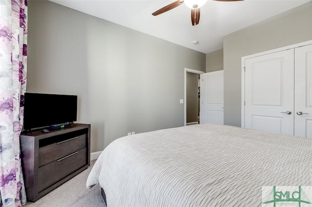 bedroom featuring light carpet, a closet, and ceiling fan